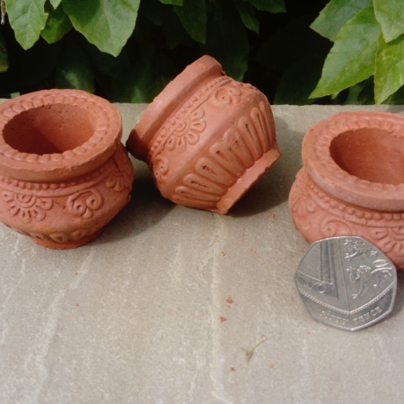 Small clay oil lamps shaped like cooking pots