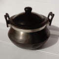 Photo of a black terracotta traditional shape cooking pot with handles