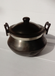 Photo of a black terracotta traditional shape cooking pot with handles