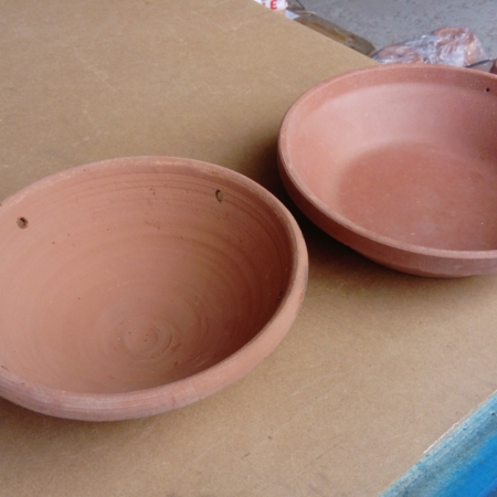 Photo of 2 unglazed pot bird feeder dishes